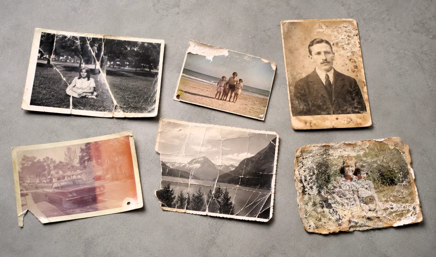 Water-damaged torn photograph showing emulsion loss chemical staining and missing sections