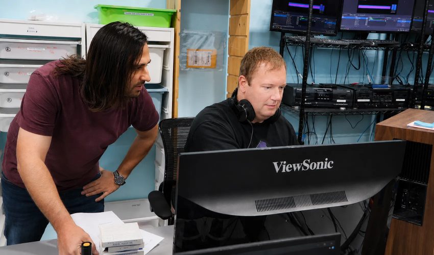 Audio engineer reviewing digitized cassette transfer waveforms on studio workstation