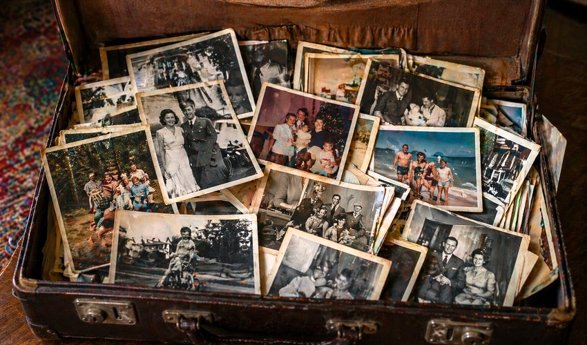 Box of old family photos ready for professional scanning and digitization