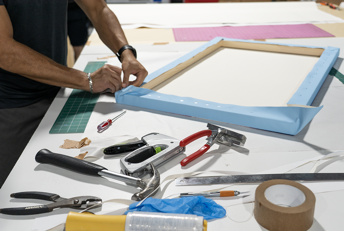 Forever Studios workspace with tools and materials used for NASA artwork restoration project