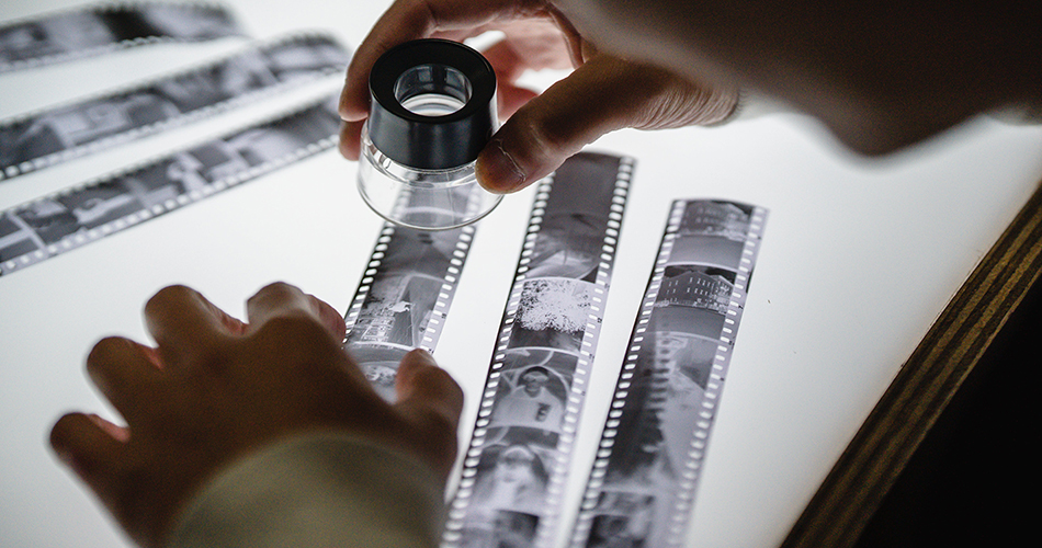Person looking at photo negatives
