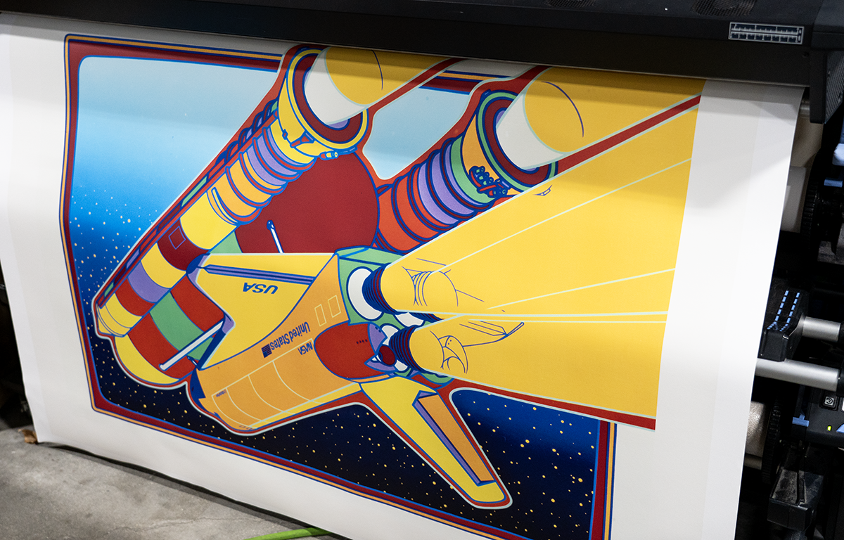 Completed restored NASA artwork print being examined for quality by Forever Studios production team