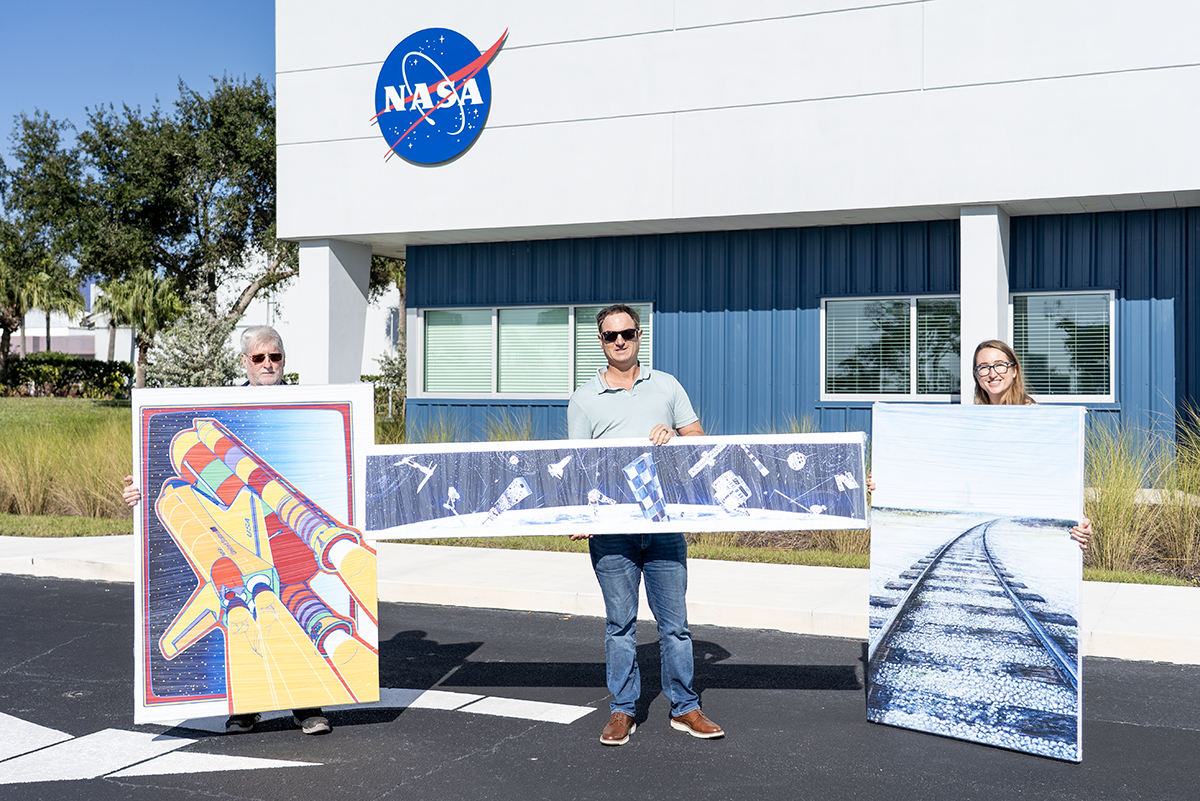 Restored NASA space artwork installed on wall at Kennedy Space Center Admin Building