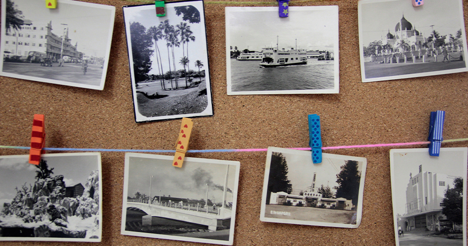 Corkboard with old black and white photos 